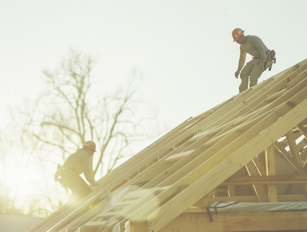 Construction Crew Working Roof Sheeting New Two Story